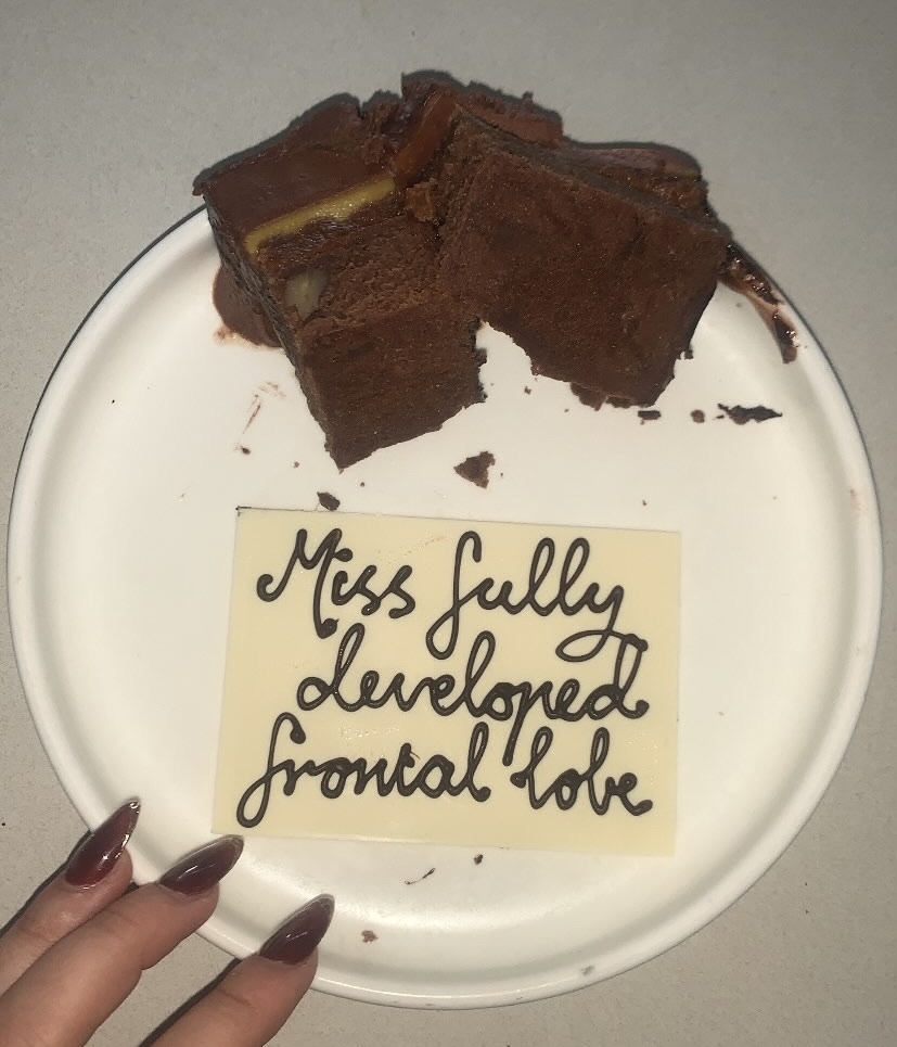 a piece of cake with miss fully developed frontal lobe written on icing